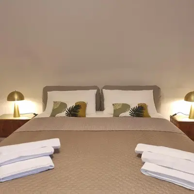 a bedroom with a bed with white towels on it at B&Baglio in Carini