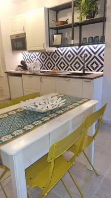a kitchen with a table and two chairs at B&Baglio in Carini