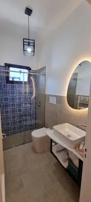a bathroom with a toilet and a sink and a shower at B&Baglio in Carini