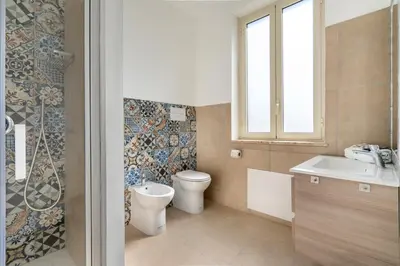 a bathroom with a toilet and a sink at Mondello House in Palermo
