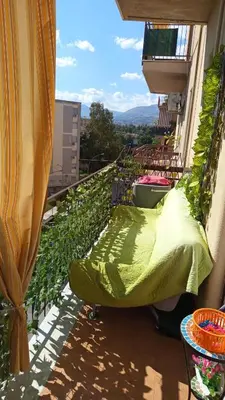 a balcony with a bed and plants on it at Dolce Sicily a 2km dal centro in Palermo