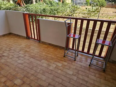 a balcony with two chairs and a railing at Guests's Nest in Castellammare del Golfo