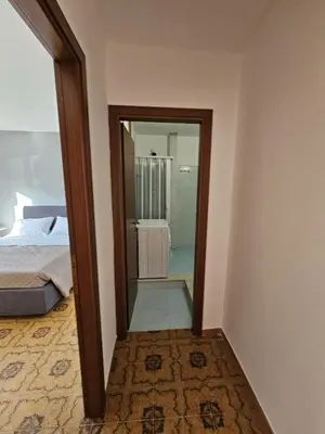 a room with a mirror and a bed and a bedroom at Guests's Nest in Castellammare del Golfo