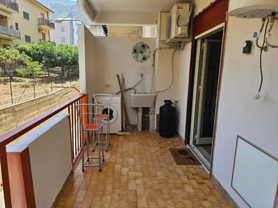 a room with a balcony with a toilet and a window at Guests's Nest in Castellammare del Golfo