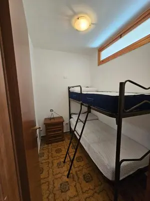 a room with two bunk beds and a window at Guests's Nest in Castellammare del Golfo