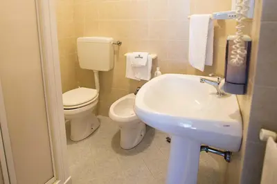 a small bathroom with a toilet and a sink at Albergo La Principessa in Alcamo