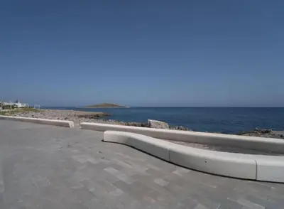 a walkway next to the ocean with the ocean at La Casetta di Ale in Isola delle Femmine