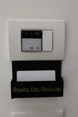 a microwave on a wall with a sign on it at De Spuches House in Caccamo