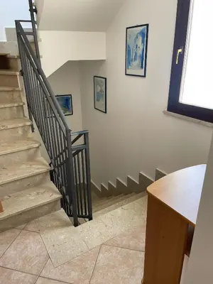 a staircase in a room with a stair case at Casa Joe in San Vito lo Capo