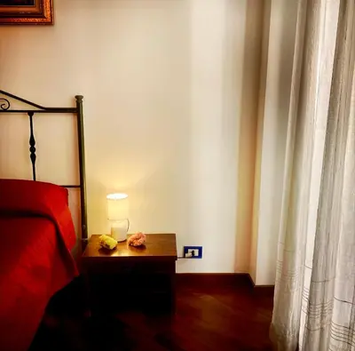 a bedroom with a bed and a lamp on a table at Casa del Blu in Palermo
