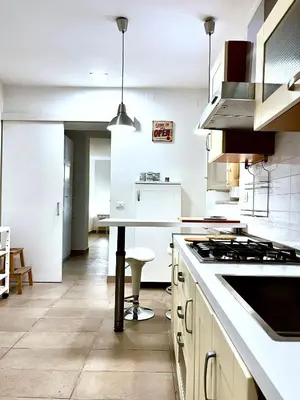 a kitchen with white counters and a stove top oven at Casetta Bontà in Palermo
