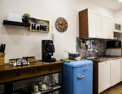 a kitchen with a blue refrigerator and a counter at Scillò House in Palermo