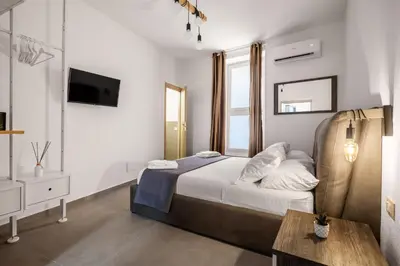 a bedroom with a bed and a television in it at G e B Central Apartment in Palermo