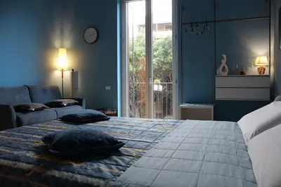 a bedroom with a bed with two pillows on it at FALSTAFF Rooms & Suites in Palermo