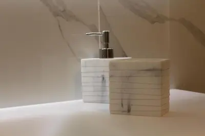 a toothbrush sitting on top of three rolls of toilet paper at FALSTAFF Rooms & Suites in Palermo