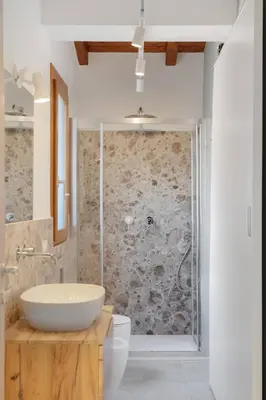 a bathroom with a white sink and a shower at Villa Eos con piscina privata in Scopello