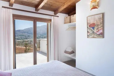a bedroom with a bed and a window with a view at Villa Eos con piscina privata in Scopello