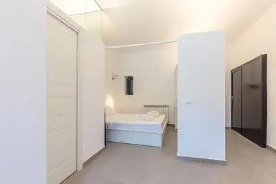 a white bathroom with a sink and a shower at Loft Piazza Marina By DomuSicily in Palermo