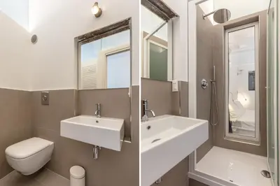 a bathroom with a sink and a toilet and a mirror at Loft Piazza Marina By DomuSicily in Palermo