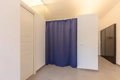 a hallway with a blue curtain and a closet at Loft Piazza Marina By DomuSicily in Palermo