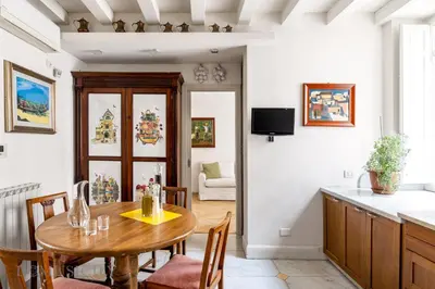 a kitchen and dining room with a table and chairs at Elvi Penthouse by DomuSicily in Palermo