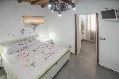 a bedroom with a bed with pink flowers on it at La Casa di Sciù Sciù in Palermo