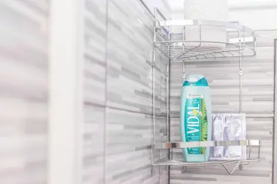a shelf with a bottle of toothpaste and a toothbrush at La Casa di Sciù Sciù in Palermo