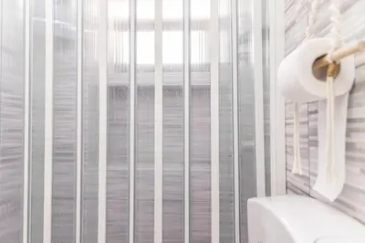 a bathroom with a window with a roll of toilet paper at La Casa di Sciù Sciù in Palermo