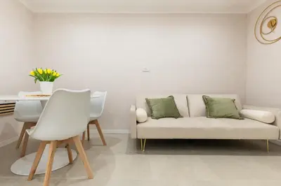 a living room with a white couch and a table at Ambrosia Suite in Palermo