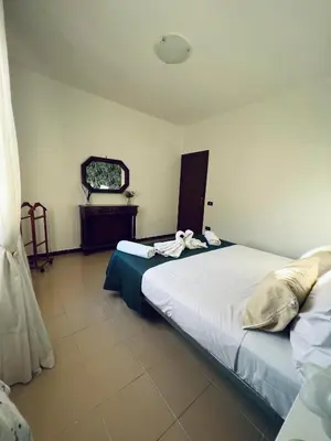 a bedroom with a large bed with towels on it at Sun House in Palermo