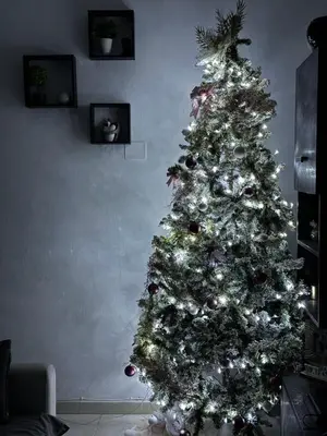 a christmas tree with decorations in a living room at Sun House in Palermo