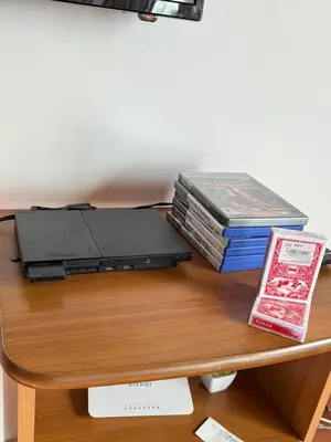 a desk with a laptop and a stack of books at Sun House in Palermo