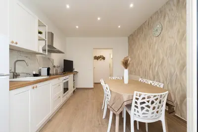 a kitchen and dining room with a table and chairs at Ludo Holiday House - Charming con patio a due passi dalla cattedrale in Palermo