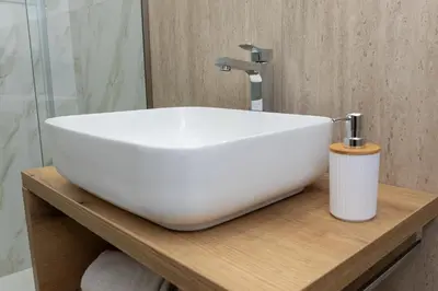 a white sink on a wooden counter in a bathroom at Ludo Holiday House - Charming con patio a due passi dalla cattedrale in Palermo