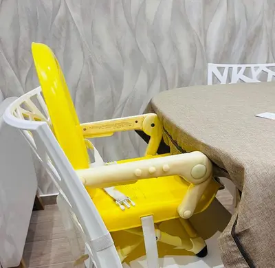 a yellow chair sitting next to a table at Ludo Holiday House - Charming con patio a due passi dalla cattedrale in Palermo
