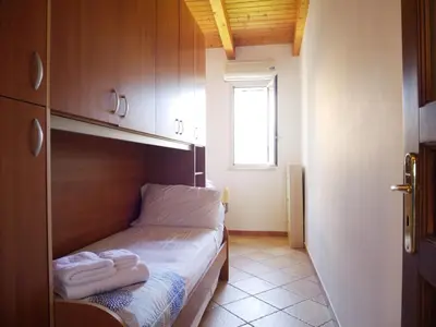 a small room with a bed with towels on it at Casa del pescatore - fronte mare di Mondello - By Rentalbeb italy- in Palermo