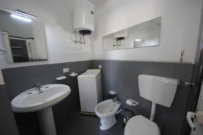 a small bathroom with a sink and a toilet at IRIS HOME Private Pool in Alcamo