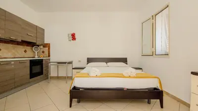 a table and chairs on a balcony with a staircase at Villa Lumia in Campofelice di Roccella
