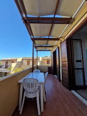 a patio with a table and chairs on a balcony at Triskelia in San Vito lo Capo