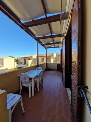 a balcony with a table and chairs and a view at Triskelia in San Vito lo Capo