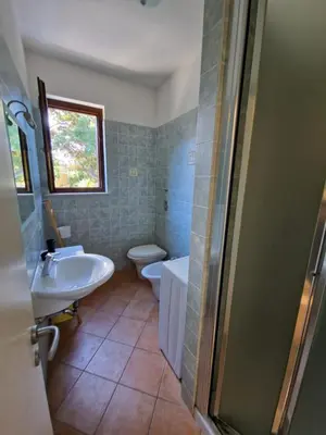 a bathroom with a sink and a toilet and a shower at Triskelia in San Vito lo Capo