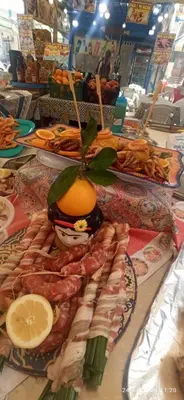 a table with a bunch of meats and fruits and vegetables at Jujube hortus apartment 4 in Palermo