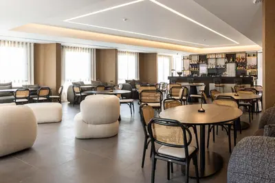a restaurant with tables and chairs in a room at Mondello Glam Hotel & Terrace in Mondello