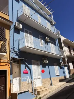 a blue building with white windows and balconies at Stella Maris Case Vacanze in Balestrate