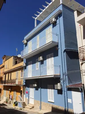 a blue building with white windows and balconies at Stella Maris Case Vacanze in Balestrate