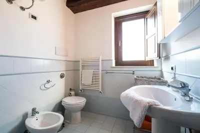 a white bathroom with a sink and a toilet at La Terrazza di Massimo in Palermo