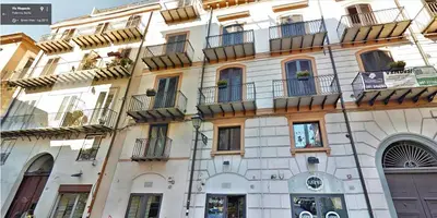 a building with balconies on the side of it at La Terrazza di Massimo in Palermo