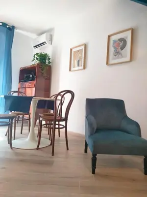 a living room with a table and chairs at Liberty Blue House in Palermo