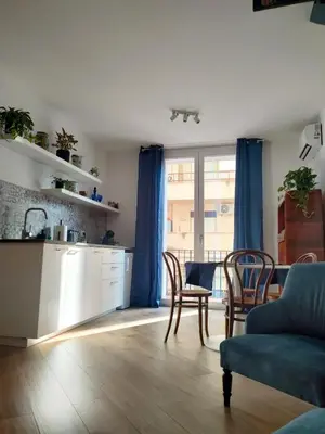 a living room with a kitchen and a table and chairs at Liberty Blue House in Palermo