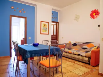 a living room with a table with chairs and a couch at Casa del pescatore Appartment -By Rentalbeb italy- in Palermo